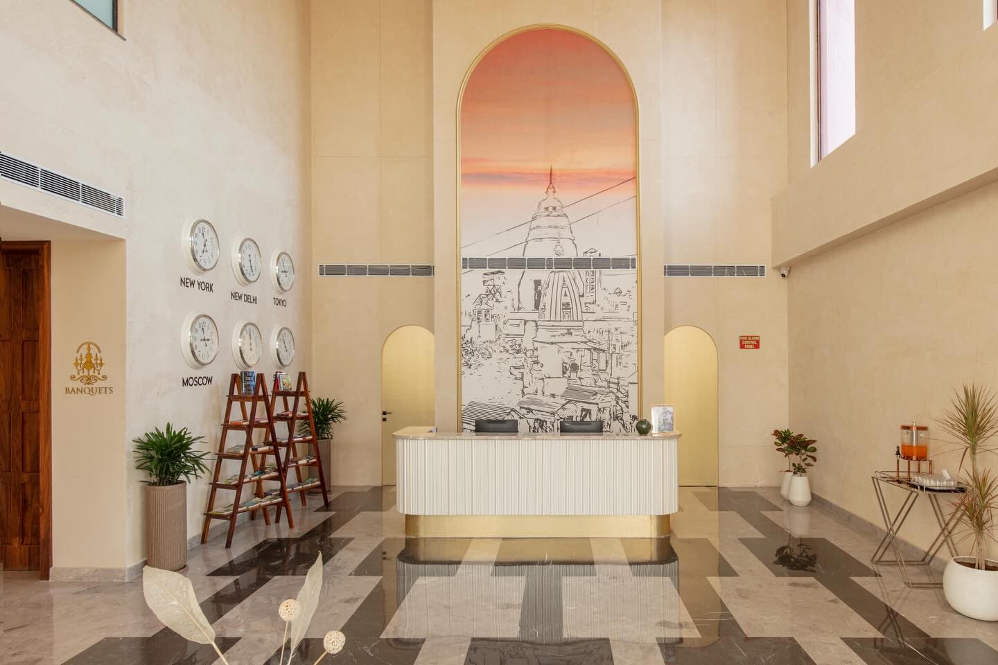 Arrival lobby at Clarks Safari — fluted desk under the Haridwar mural